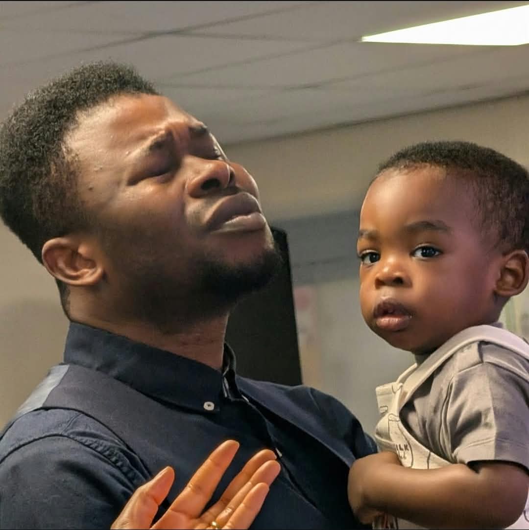 Father worshipping with his child